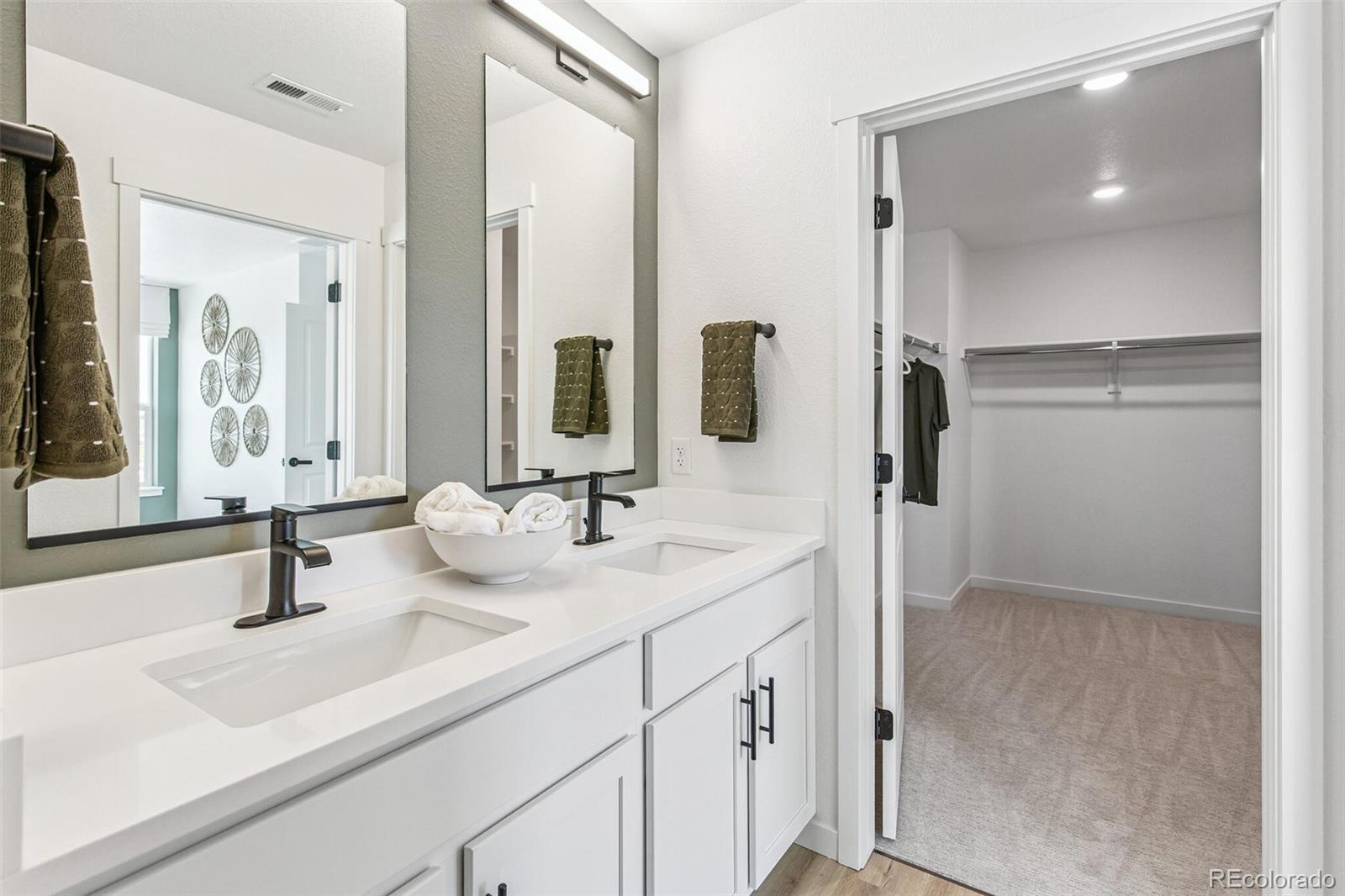 1374 South Chester Street, Unit A Denver, CO 80247 - Photo 26 of 35 a bathroom with a sink and mirror