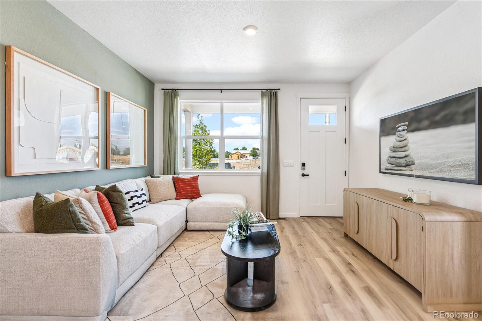 1374 South Chester Street, Unit A Denver, CO 80247 - Photo 5 of 35 a living room with furniture and a large window