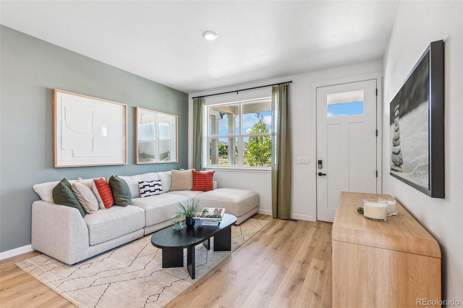 1374 South Chester Street, Unit A Denver, CO 80247 - Photo 6 of 35 a living room with furniture and a large window