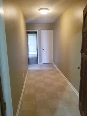 a view of an empty room and closet area