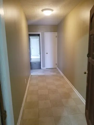 a view of an empty room and closet area