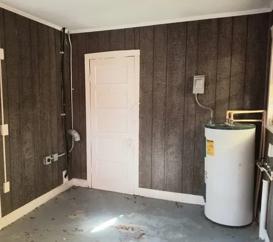 a view of a storage & utility room with wooden walls