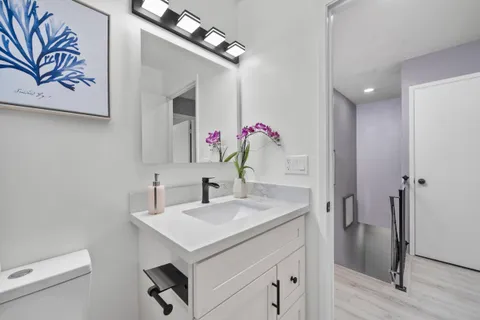 a bathroom with a sink vanity and a mirror