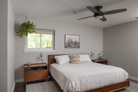a bedroom with a bed and a ceiling fan