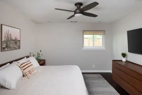 a bedroom with a bed and a flat screen tv