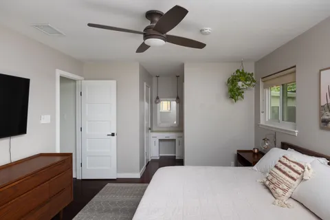 a bedroom with a bed and a television