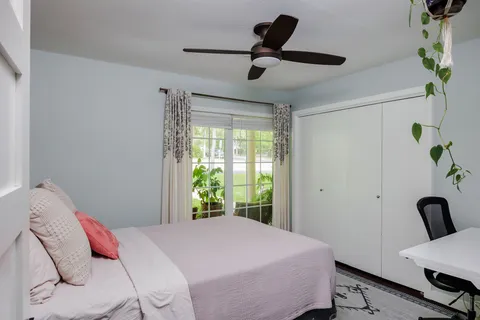 a bedroom with a bed and a chair