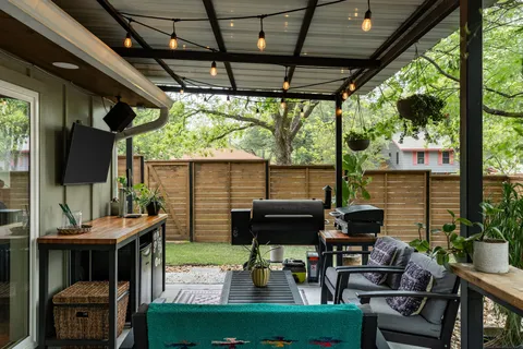 a building outdoor space with patio furniture and potted plants