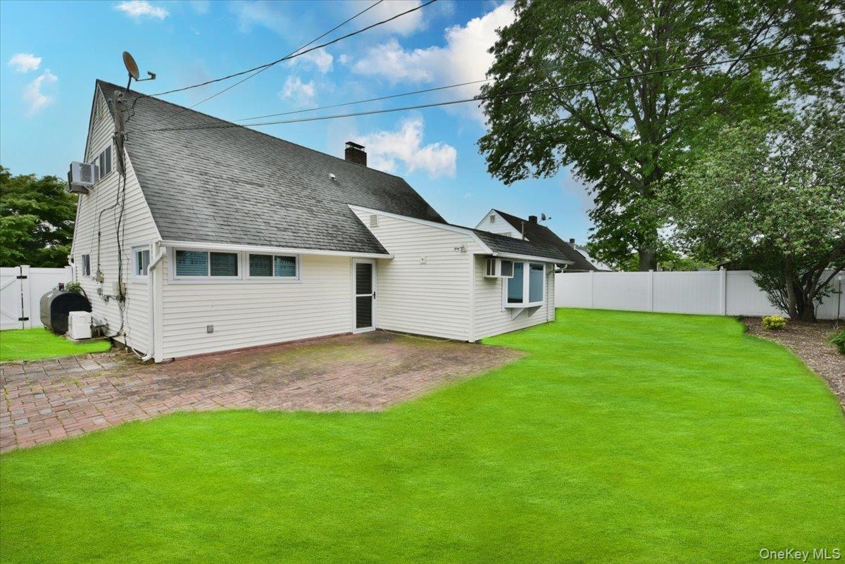 307 Blacksmith Road Levittown, NY 11756 - Photo 25 of 27 a view of a house with a backyard