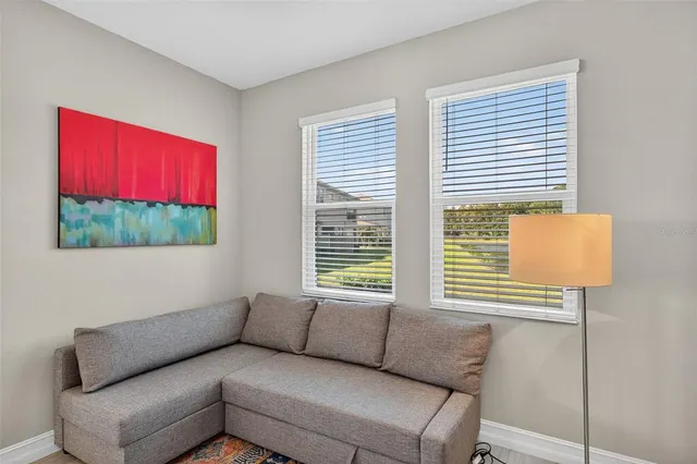 a bathroom with a sink a toilet and a picture on the wall
