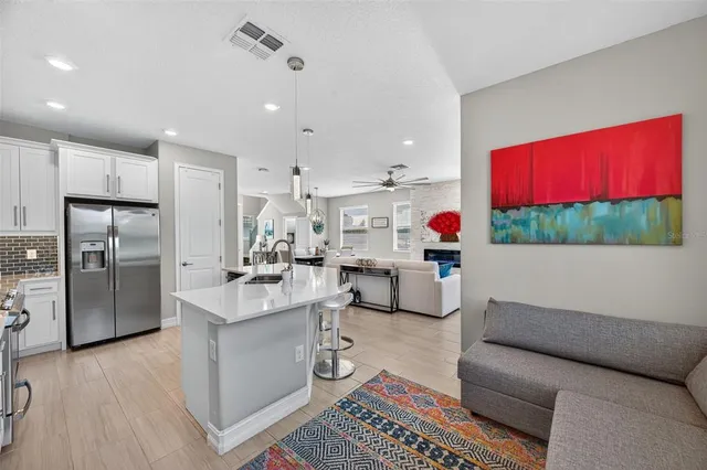 a bathroom with a sink a toilet and a picture on the wall