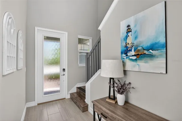 a living room with couches a dining table and chairs with outer view