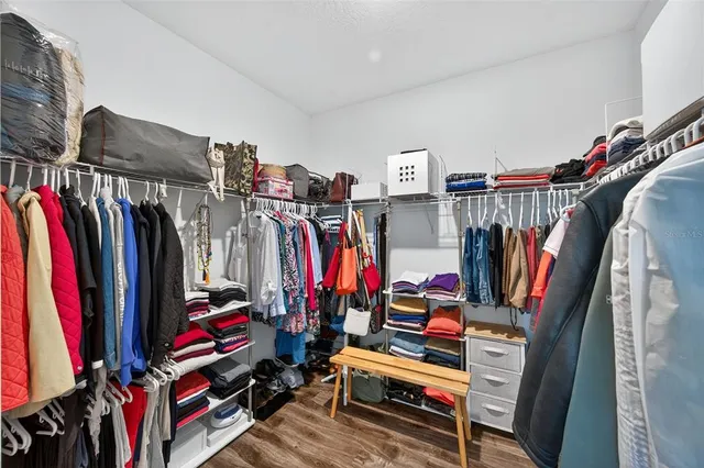 a living room with furniture a fireplace and chandelier