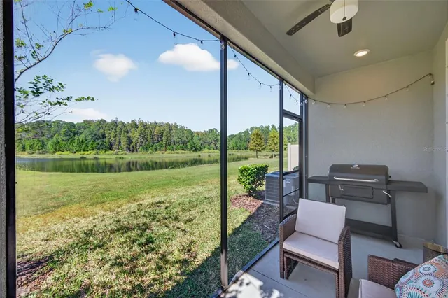 a living room filled with furniture and floor to ceiling window