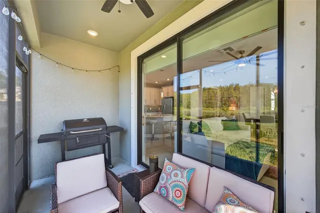 a living room filled with furniture and floor to ceiling window