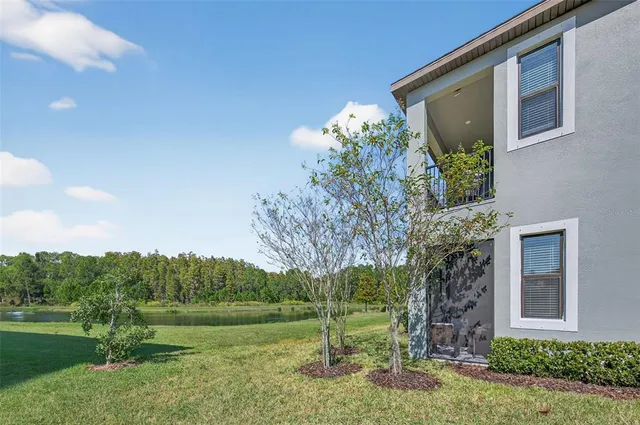 a view of swimming pool with a yard and large tree