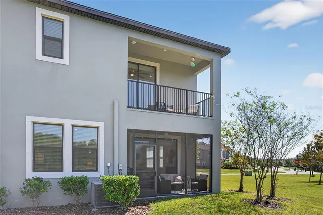 an aerial view of a house with a yard and large trees