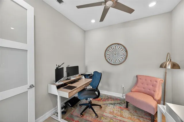 a kitchen with stainless steel appliances a stove a sink a microwave a refrigerator a stove a dining table and chairs