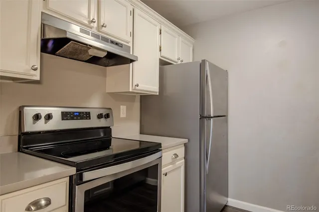 a kitchen with stainless steel appliances a refrigerator and a stove top oven
