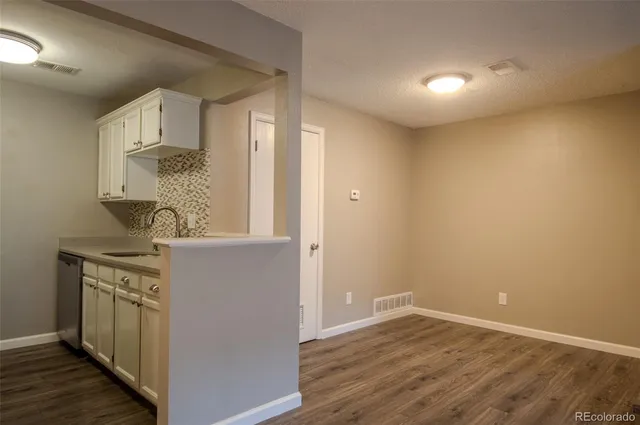 a view of kitchen with sink and wooden floor