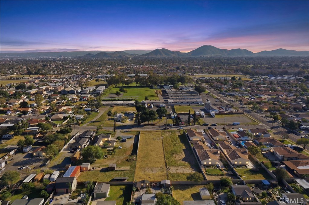 17562 Court Street Fontana, CA 92336 - Photo 1 of 16 an aerial view of residential houses with outdoor space and trees