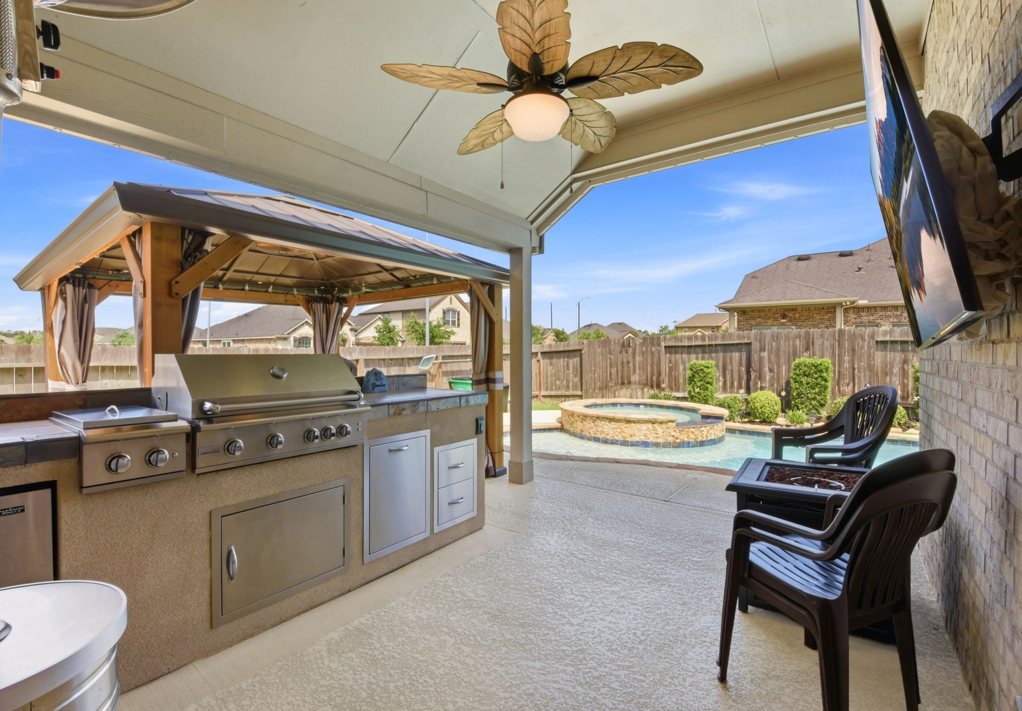 3811 Oakmist Bend Lane Spring, TX 77386 - Photo 16 of 23 a living room with furniture a fireplace and a flat screen tv