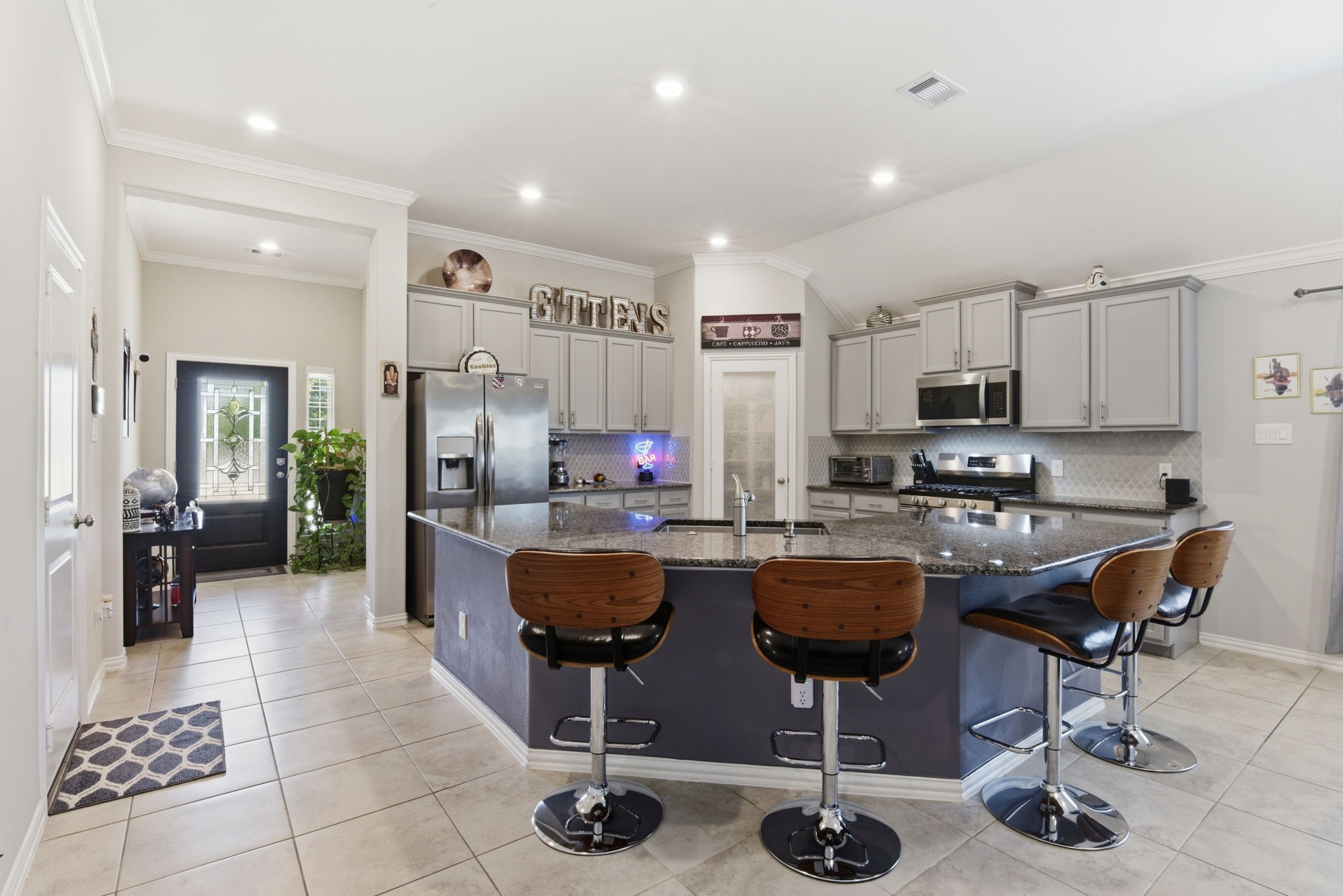 3811 Oakmist Bend Lane Spring, TX 77386 - Photo 6 of 23 a kitchen with stainless steel appliances kitchen island granite countertop a stove a sink a refrigerator and chairs