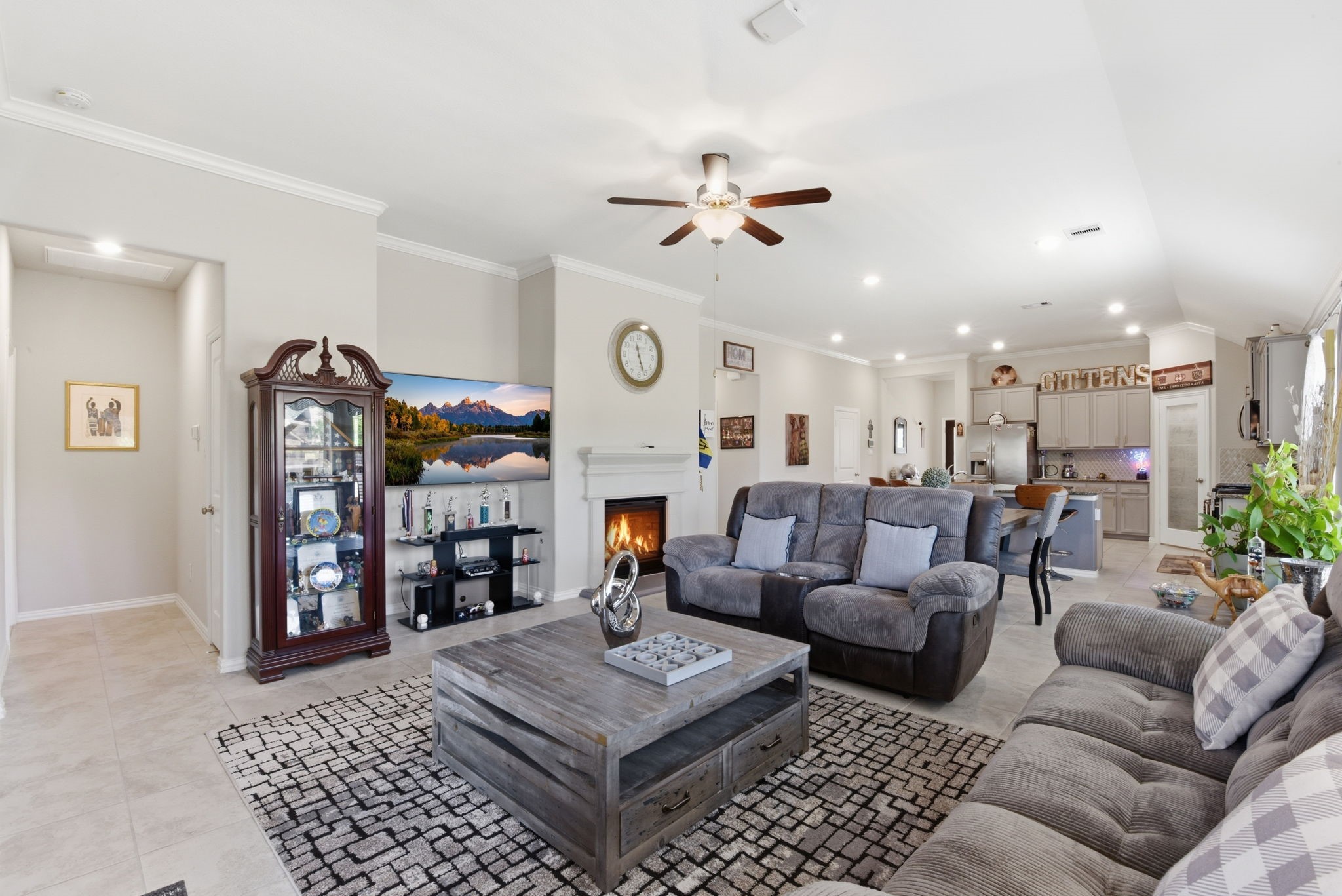 3811 Oakmist Bend Lane Spring, TX 77386 - Photo 8 of 23 a living room with furniture a ceiling fan and a bookshelf