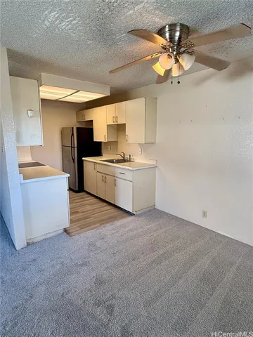 a view of a kitchen with a sink and a stove top oven