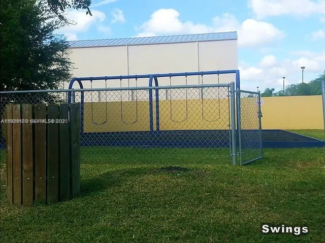 a view of a swimming pool with lawn chairs and couches