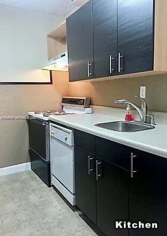 a kitchen with a sink and cabinets