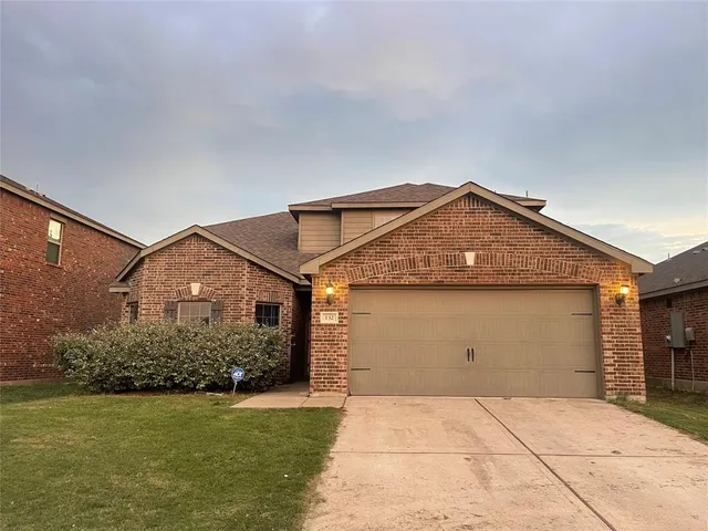 a view of a house with a yard and garage