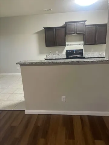 a view of kitchen with stainless steel appliances a sink and a microwave