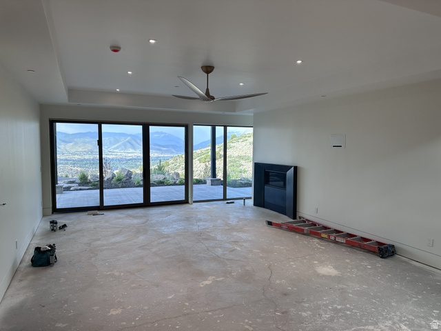 1918 Chimney Rock Road Heber City, UT 84032 - Photo 49 of 74 Expansive interior space featuring a full wall of sliding glass doors, a built-in fireplace with a dark surround, and a ceiling fan