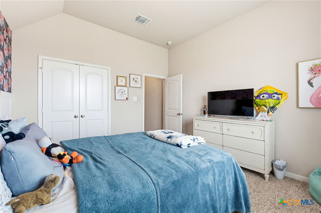 1761 Spence Street Temple, TX 76502 - Photo 20 of 30 a bedroom with a bed and flat screen tv
