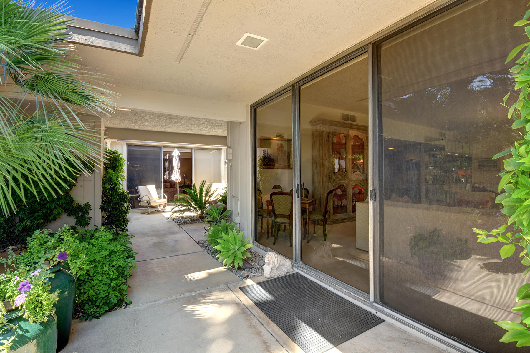 30 Duke Drive Rancho Mirage, CA 92270 - Photo 34 of 38 LIVING ROOM PATIO TO ENTRY WALK