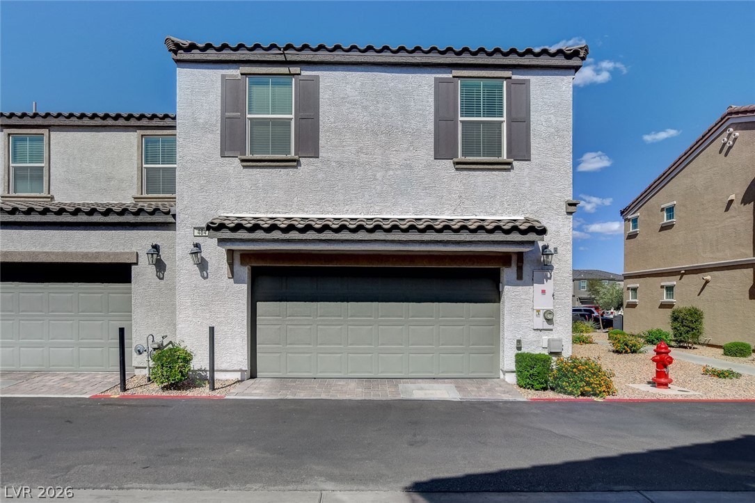 484 Filaree Place Henderson, NV 89015 - Photo 57 of 71 This charming home showcases a durable stucco exterior, a practical garage, and decorative window shutters.