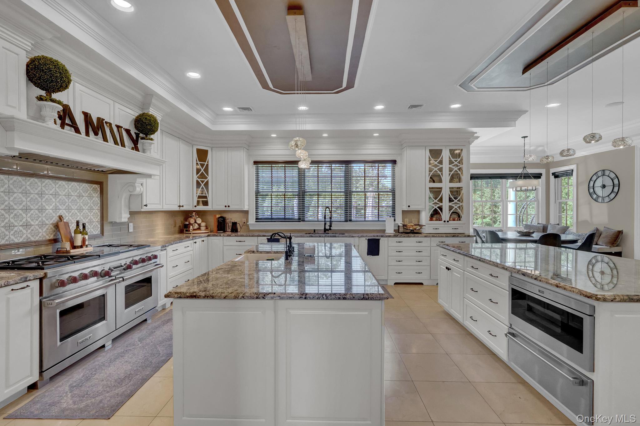 36 Old Field Road Setauket, NY 11733 - Photo 24 of 42 a large kitchen with stainless steel appliances granite countertop a large stove a sink dishwasher and white cabinets with wooden floor