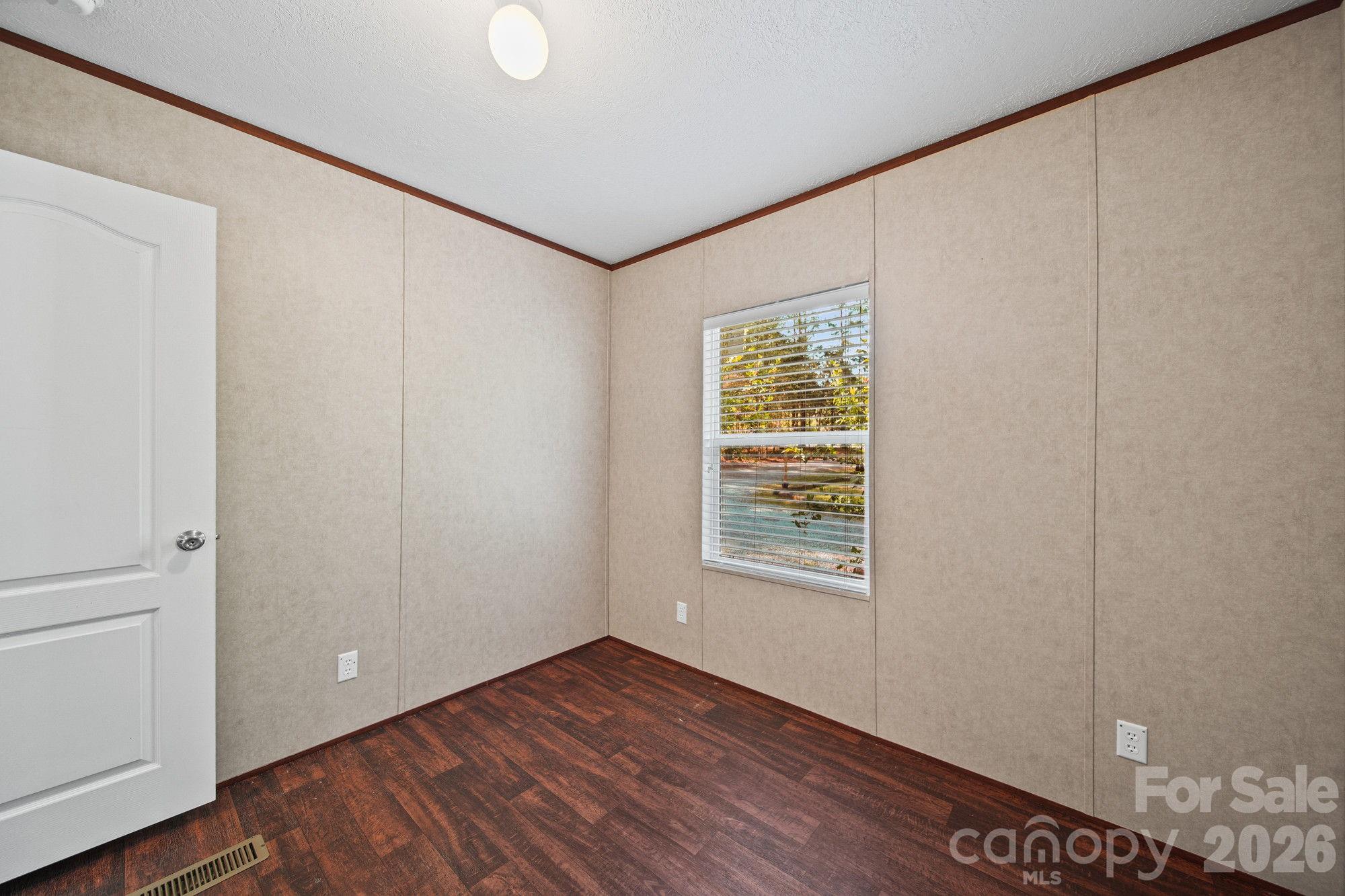 4507 White Store Road Wingate, NC 28174 - Photo 24 of 29 a view of an empty room with wooden floor and a window