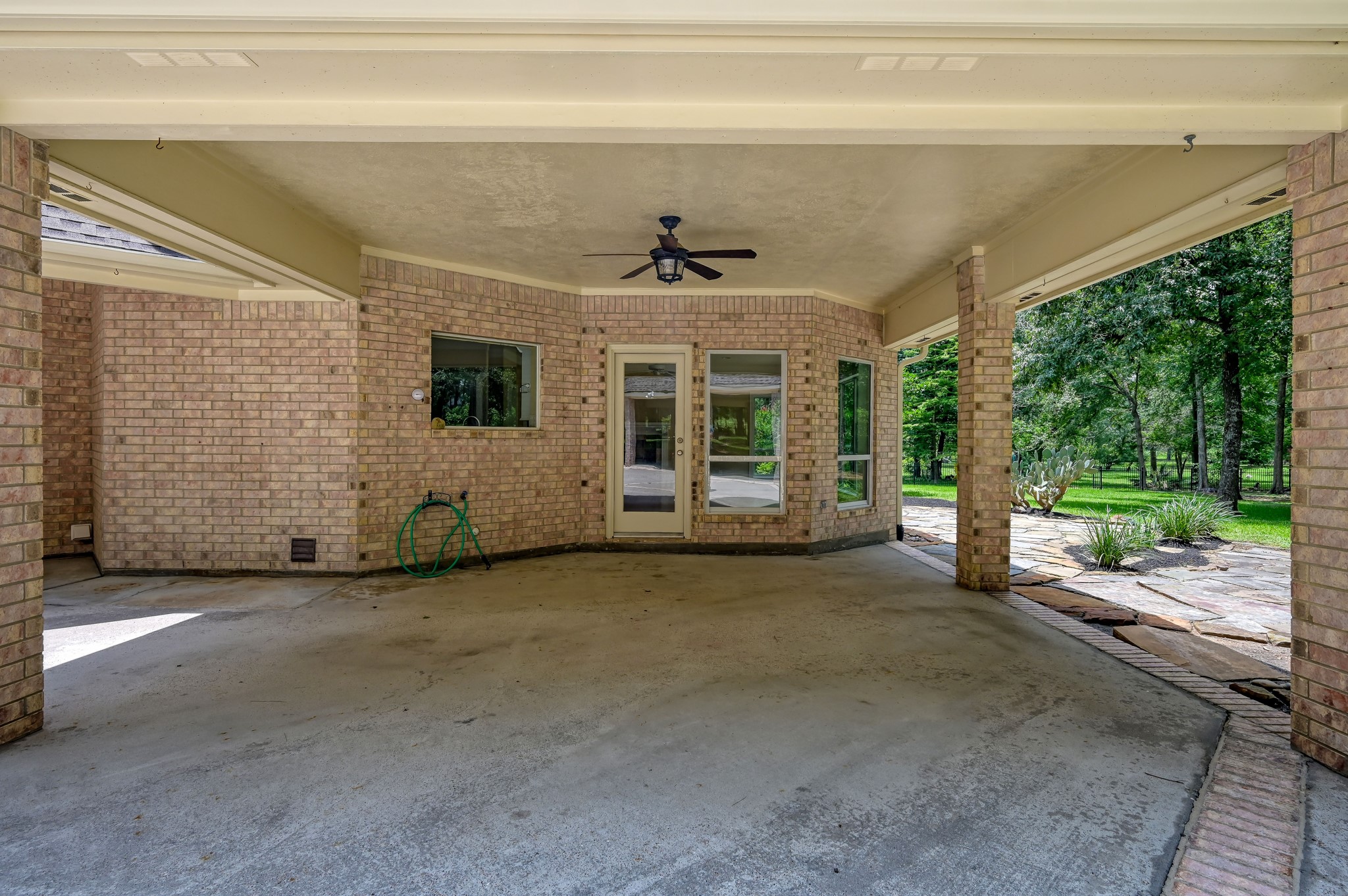 2205 Longmire Road Conroe, TX 77304 - Photo 36 of 49 Roomy covered patio with an outdoor ceiling fan sits right off of the family room.