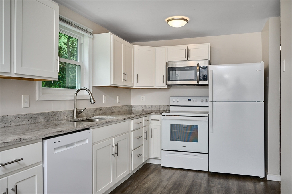 48 Austin Circle Northampton, MA 01062 - Photo 5 of 33 a kitchen with white cabinets white stainless steel appliances and sink