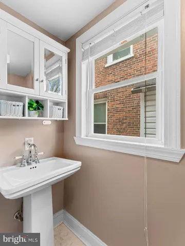a bathroom with a sink and a window
