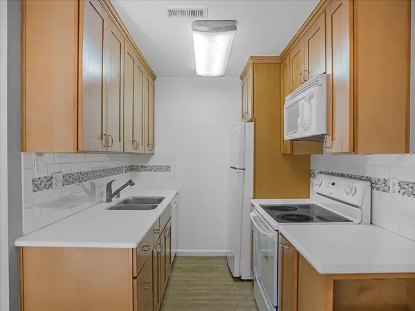 a stove top oven sitting inside of a kitchen