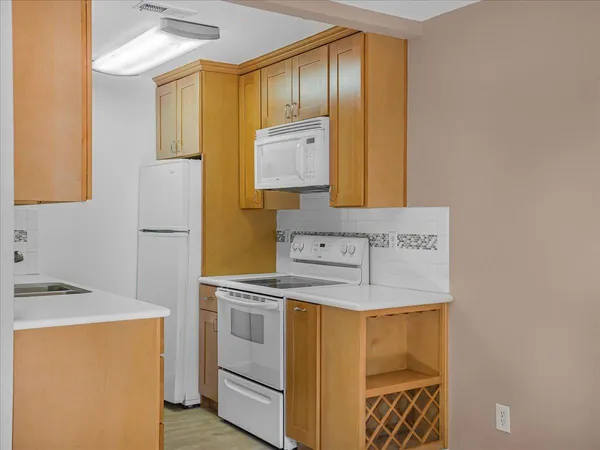 a kitchen with stainless steel appliances granite countertop a sink and a cabinets