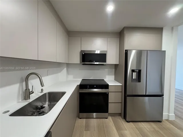 a kitchen with a refrigerator sink and microwave