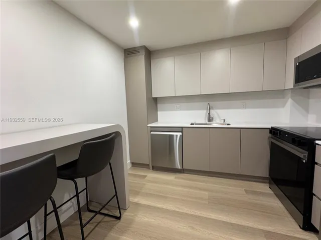 a kitchen with a sink cabinets and appliances