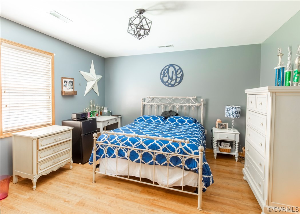 3676 Bell Road Dillwyn, VA 23936 - Photo 47 of 50 a bedroom with a bed and a refrigerator