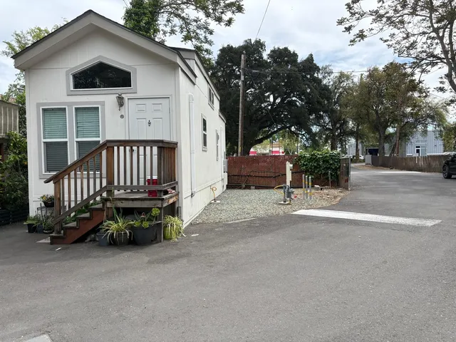a view of a house with backyard and sitting area
