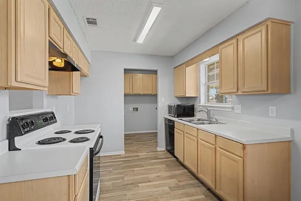 a kitchen with a stove a sink and a refrigerator