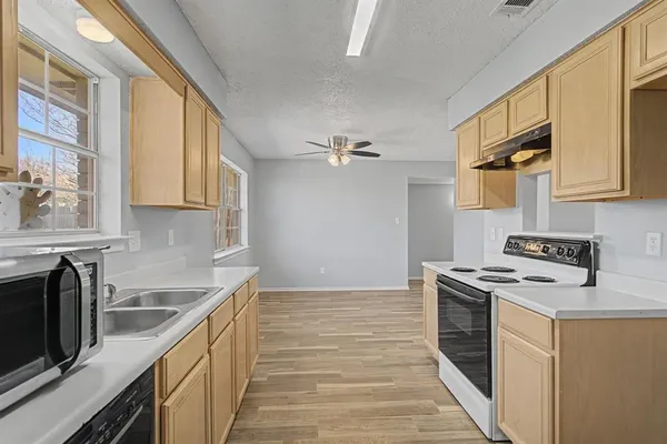 a kitchen with stainless steel appliances granite countertop a stove and a sink